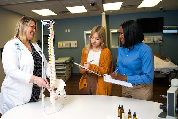 Nursing students learning from a clinical nurse educator.