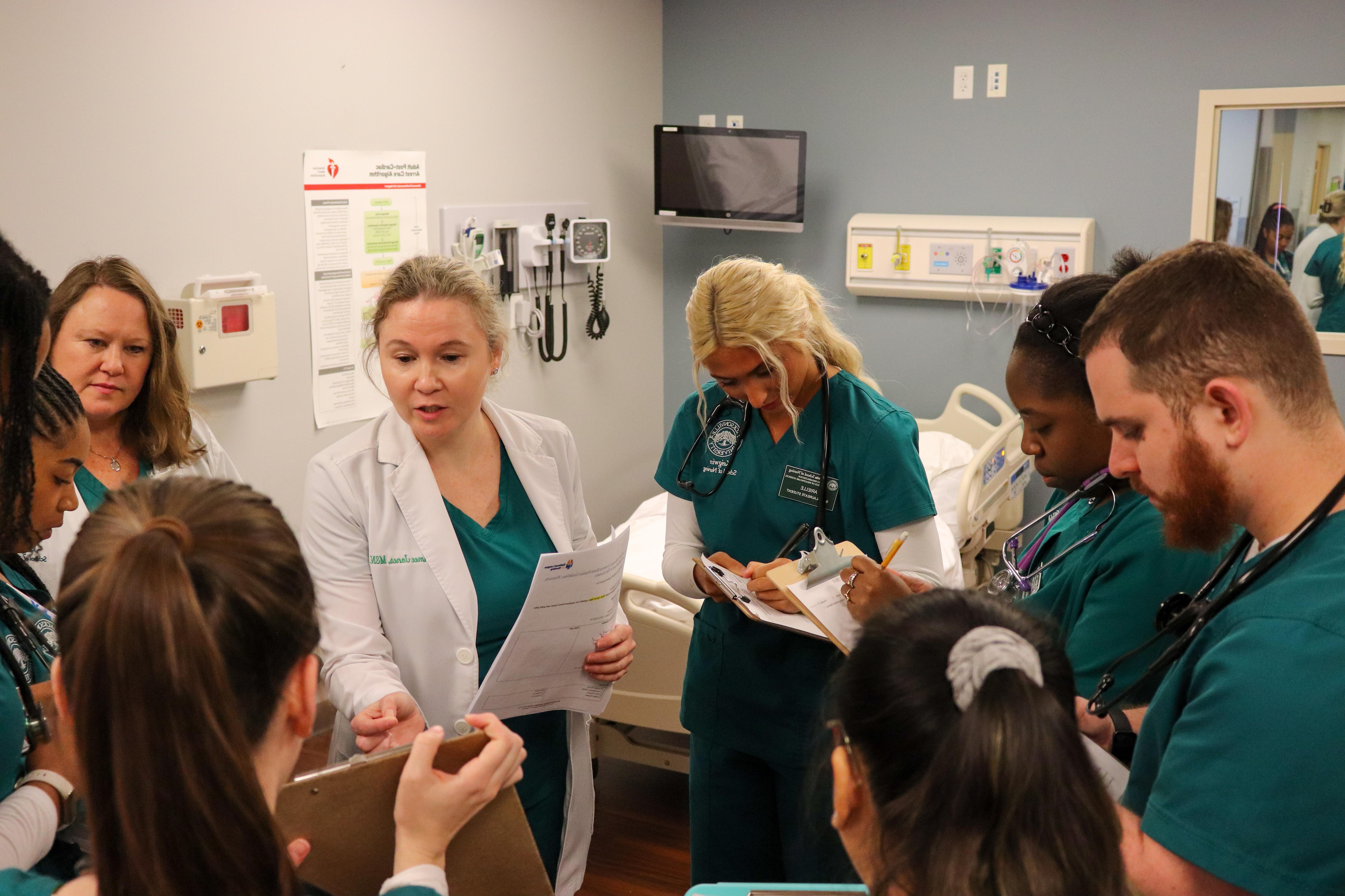 Jacksonville University professor debriefing nursing students before simulation