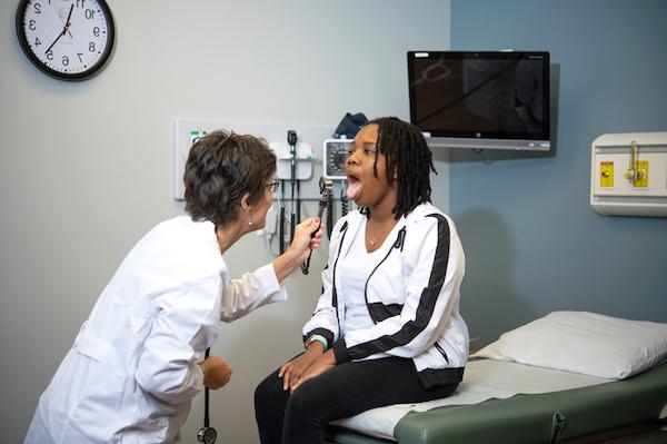 A nursing professional giving a check up to a patient.